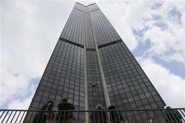 'Spiderman' climbs Paris tower in tribute to quake victims