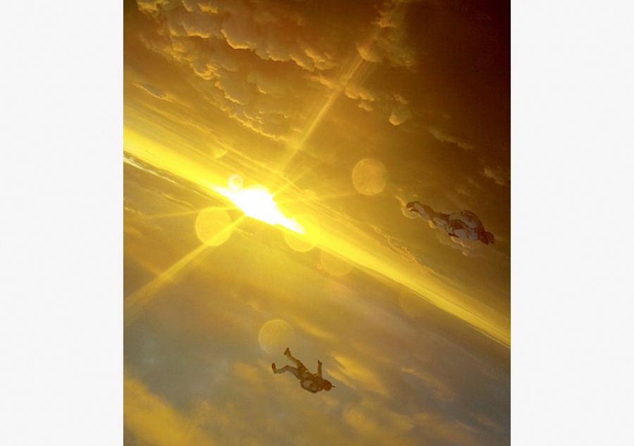 Skydivers soar through the edge of the world