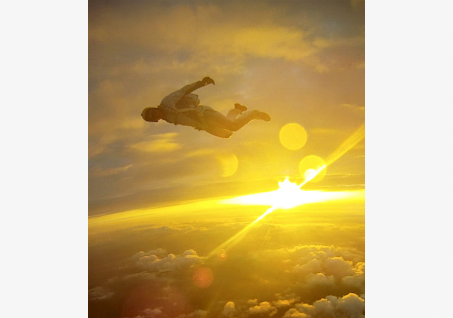 Skydivers soar through the edge of the world